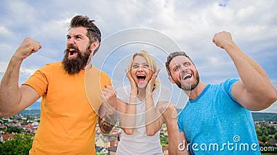 Favorite team won competition. Woman and men look successful celebrate victory sky background. Threesome stand happy Stock Photo