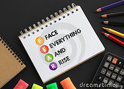 FEAR - Face Everything And Rise acronym text on notepad, concept background Stock Photo