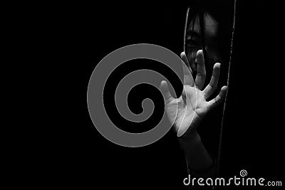 Fear girl hiding in closet with hand reaching out Stock Photo
