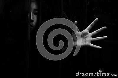 Fear girl hiding in closet with hand reaching out Stock Photo