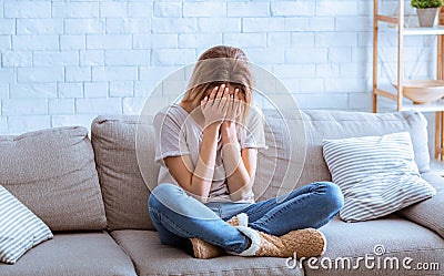 Girl in despair covered her face with hands Stock Photo