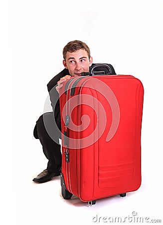 Fearful business man hide behind red luggage Stock Photo