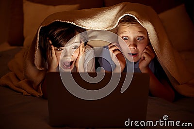 Fearful schoolboys watching scary movie Stock Photo