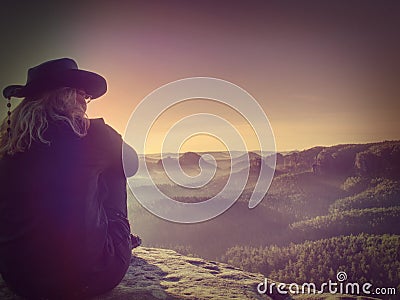 Fearless blond middle age hiker woman on the Edge Stock Photo