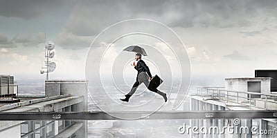 Fearless businessman overcoming difficulty. Mixed media Stock Photo