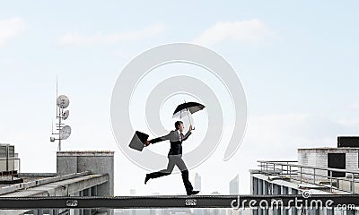 Fearless businessman overcoming difficulty. Mixed media Stock Photo