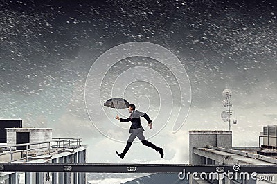 Fearless businessman overcoming difficulty. Mixed media Stock Photo