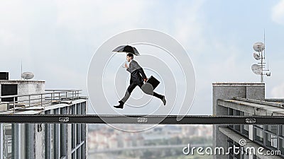 Fearless businessman overcoming difficulty. Mixed media Stock Photo