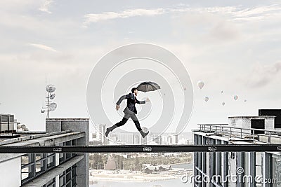 Fearless businessman overcoming difficulty. Mixed media Stock Photo