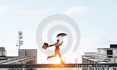 Fearless businessman overcoming difficulty. Mixed media Stock Photo