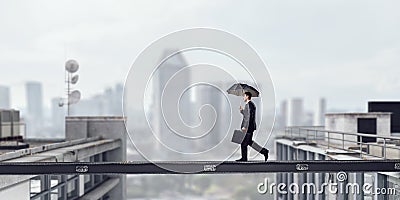 Fearless businessman overcoming difficulty. Mixed media Stock Photo