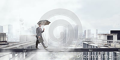 Fearless businessman overcoming difficulty. Mixed media Stock Photo