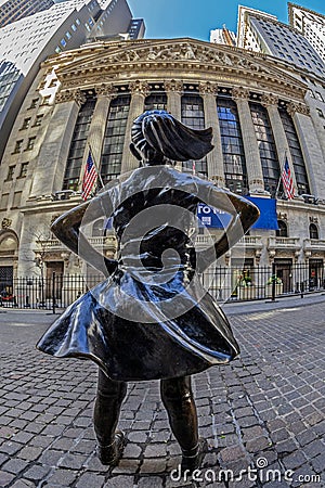 Fearless Girl bronze sculpture in front of New York Stock Exchange Editorial Stock Photo