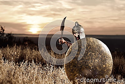 Fearless young Spartan warrior posing in the field Stock Photo