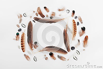 Feather frame on white background top view in flat lay style for boho theme. Empty space for text. Stock Photo