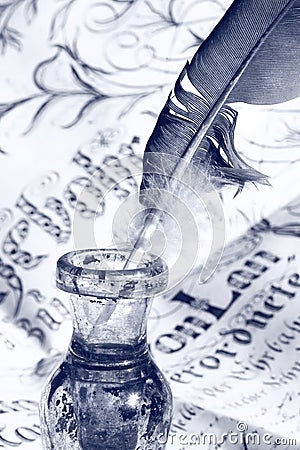 Feather in inkwell Stock Photo