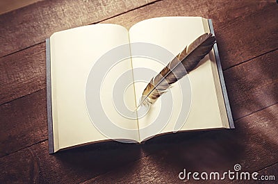 Feather on a notebook Stock Photo