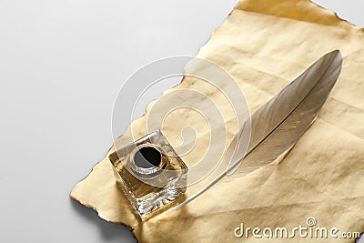 Feather pen with inkwell and blank paper Stock Photo