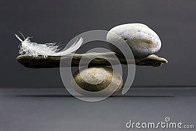 Feather and stone balance Stock Photo