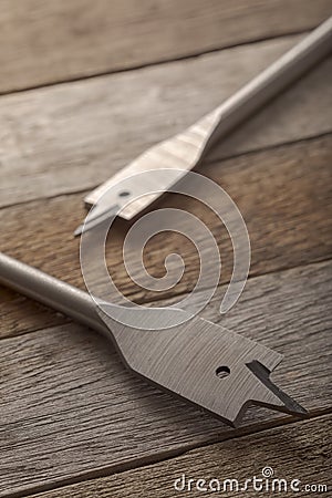 Feather wood drill bit on wooden background Stock Photo