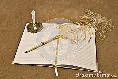 Feathered Pen Lying On Blank Open Journal Stock Photo