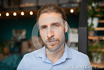 Handsome gray-eyed man wearing shirt feeling self-confidence Stock Photo