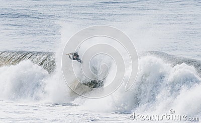 Amazing shot of a professional surfer surfing in the sea with big waves in summer Editorial Stock Photo