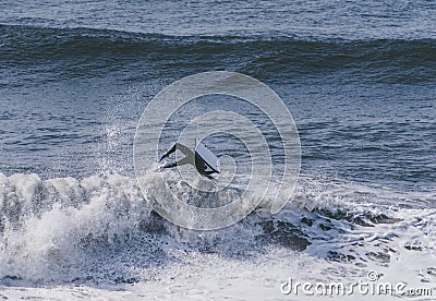 Amazing shot of a professional surfer surfing in the sea with big waves in summer Editorial Stock Photo