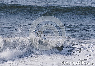 Amazing shot of a professional surfer surfing in the sea with big waves in summer Editorial Stock Photo