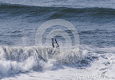 Amazing shot of a professional surfer surfing the sea with big waves in summer Editorial Stock Photo