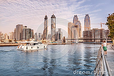 Luxury yacht or boat sails by Dubai Creek Canal at Downtown Center with stunning views of numerous Editorial Stock Photo