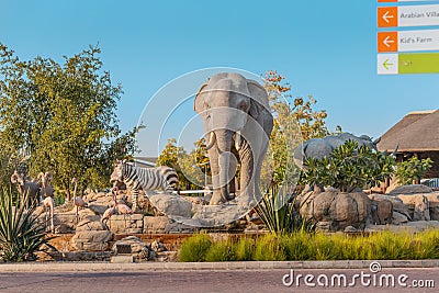Zebra, elephant and crocodile statues on an artificial fountain and waterfall in the central safari Editorial Stock Photo