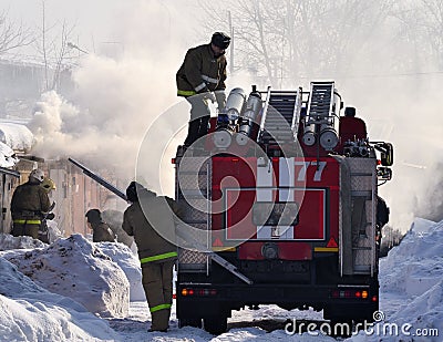 2018 February 22, A fire truck and firemen extinguish a fire. Russia. Winter season. Editorial Stock Photo