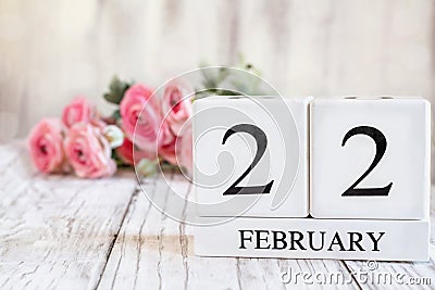 February 22nd Calendar Blocks with Pink Ranunculus in Background Stock Photo