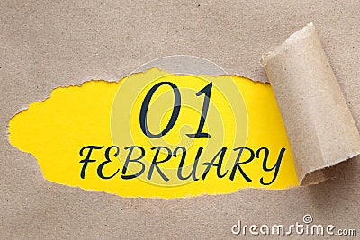 february 01. 01th day of the month, calendar date.Hole in paper with edges torn off. Yellow background is visible Stock Photo