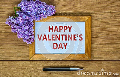 February 14 valentines day symbol. Wooden frame with words 'Happy valentines day'. Stock Photo