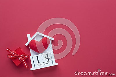 14 February wooden house calendar on a red heart background. Happy Valentineâ€™s Day top view card Stock Photo