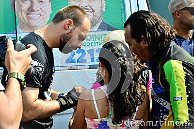 Federal Deputy Eduardo Bolsonaro autographing for the voting family in the campaign Editorial Stock Photo