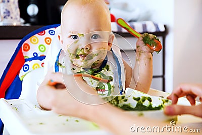 Feeding. Baby's first solid food Stock Photo