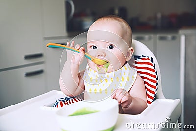 Feeding. Baby's first solid food Stock Photo