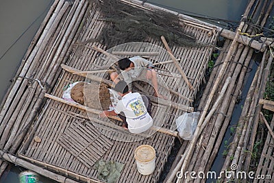 Feeding Fish in a Cage Editorial Stock Photo