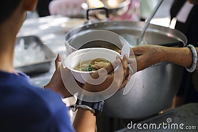 Feeding the poor to hands of a beggar. Poverty concept Stock Photo