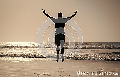 feel freedom. young and free. sport athlete jumping in the ocean. morning workout activity. Stock Photo