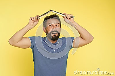 Feel safe with plan. Man mature bearded guy hold notepad as roof. Check what is done. Daily plan. Developing habits and Stock Photo