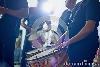 Feel their rhythm. a group of musical performers playing together indoors. Stock Photo