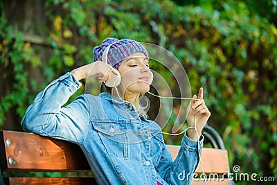 Feeling awesome. Cool funky girl enjoy music in headphones outdoor. Girl listen music in park. Melody sound and mp3 Stock Photo