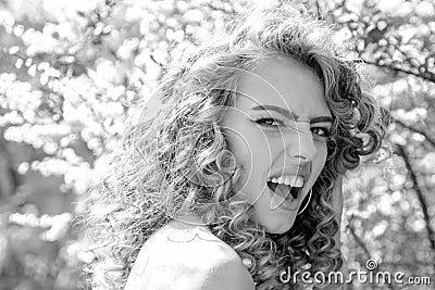 Feeling and funny emotion. Beauty Romantic woman in flowers. Sensual Lady. Romantic beauty in fantasy orchard. Beautiful Stock Photo