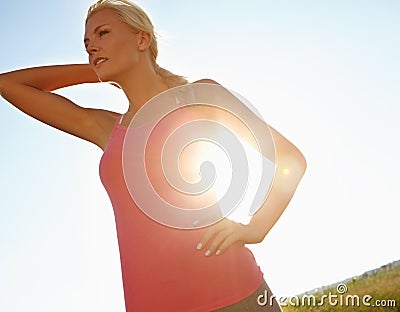 Feeling great after a jog. A young woman in sporstwear relaxing after a jog. Stock Photo