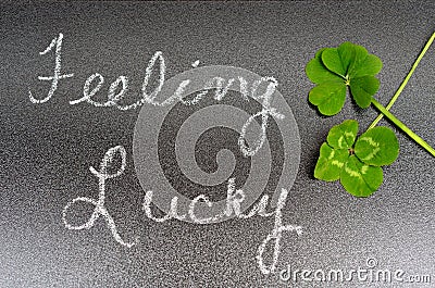 Feeling lucky concept sign, 5 five leaf and 4 leaf clover Stock Photo