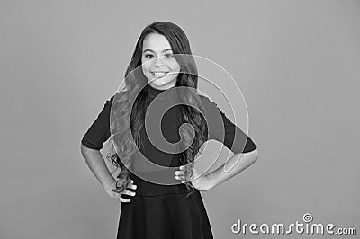 Feeling lucky. Perfect girl. Positive emotions. Teen girl smiling orange background. Teen child with long curly hair Stock Photo